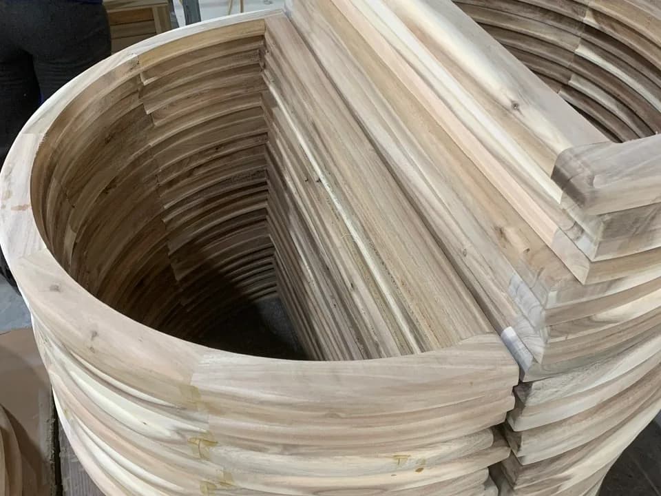 Curved timber components stacked during furniture production