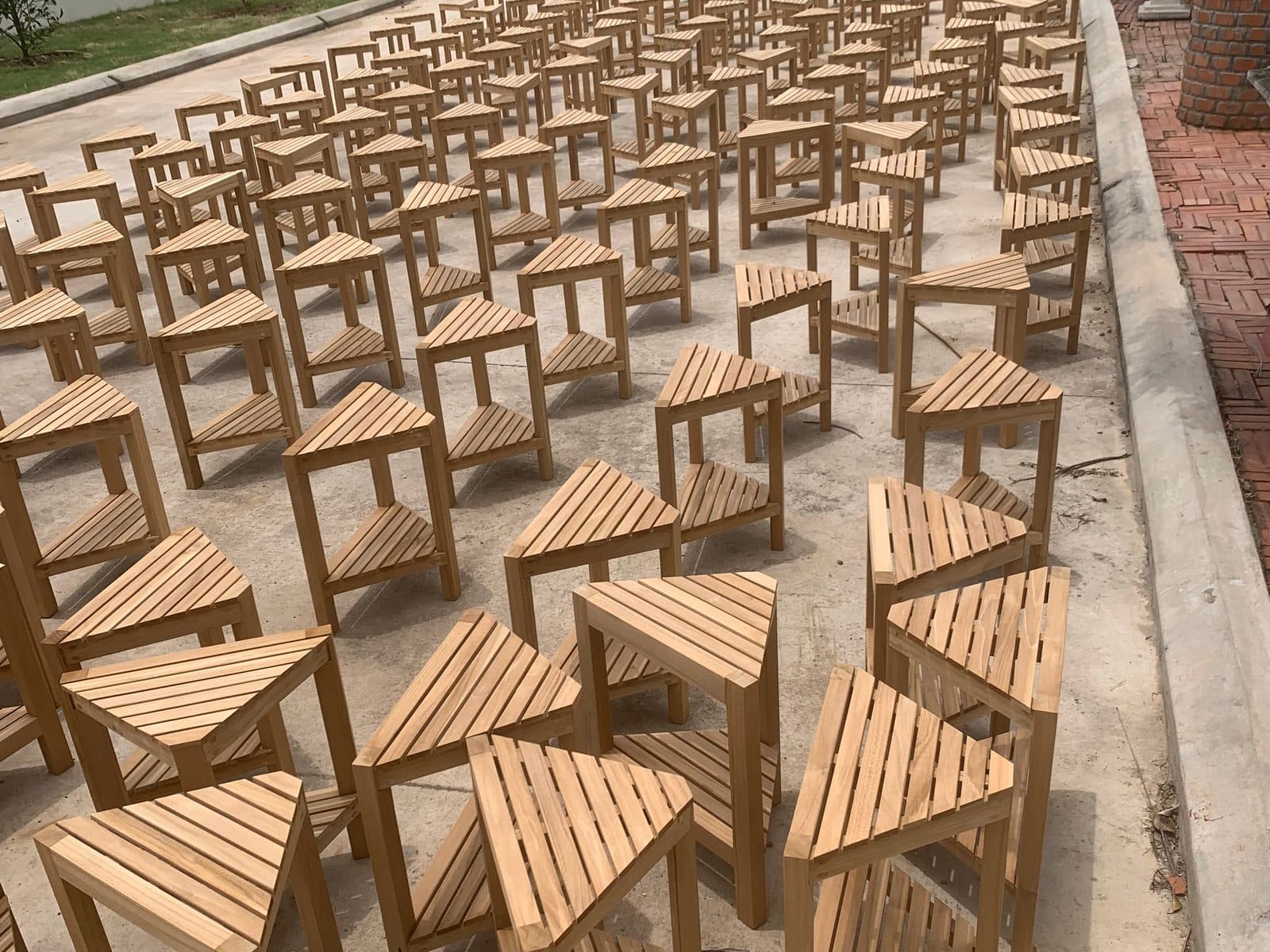 Rows of wooden chairs awaiting review at a manufacturing site