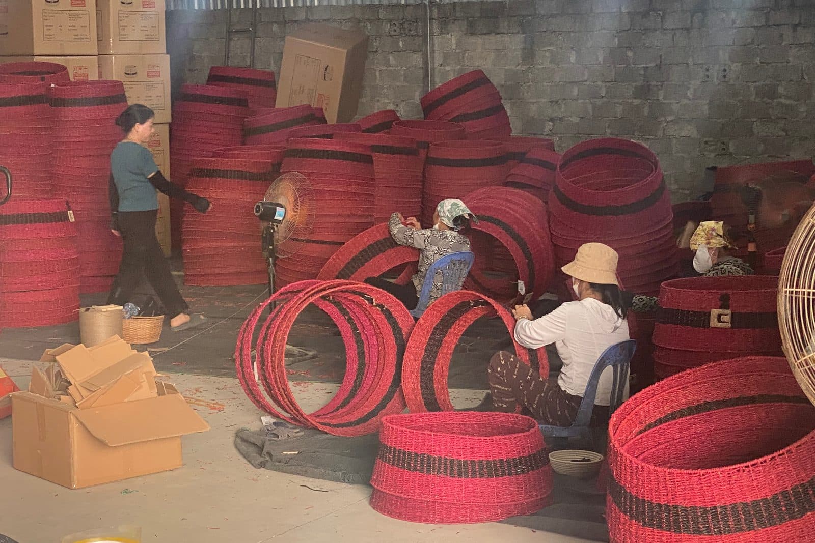 Workers producing woven baskets in a Vietnamese workshop